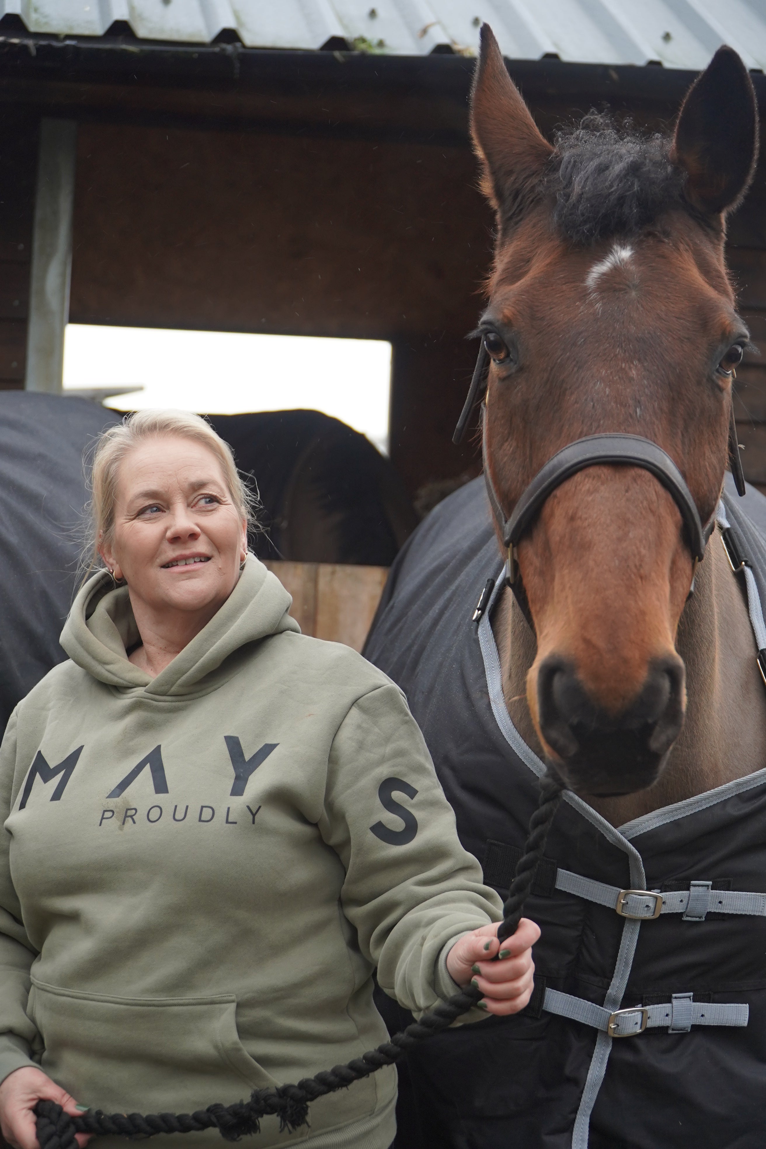 Person wearing a hoodie with text, standing next to a horse in an indoor setting. A person wearing a green hoodie with a large hood, standing next to a white horse. The person is wearing black pants and black boots, and the hoodie has the word 'Equestrian' written on it.
High quality luxurious 100% cotton. wrap around bold logo. soft, cozy and warm. Hoodie, jumper sweatshirt. everyday wear. casual and smart