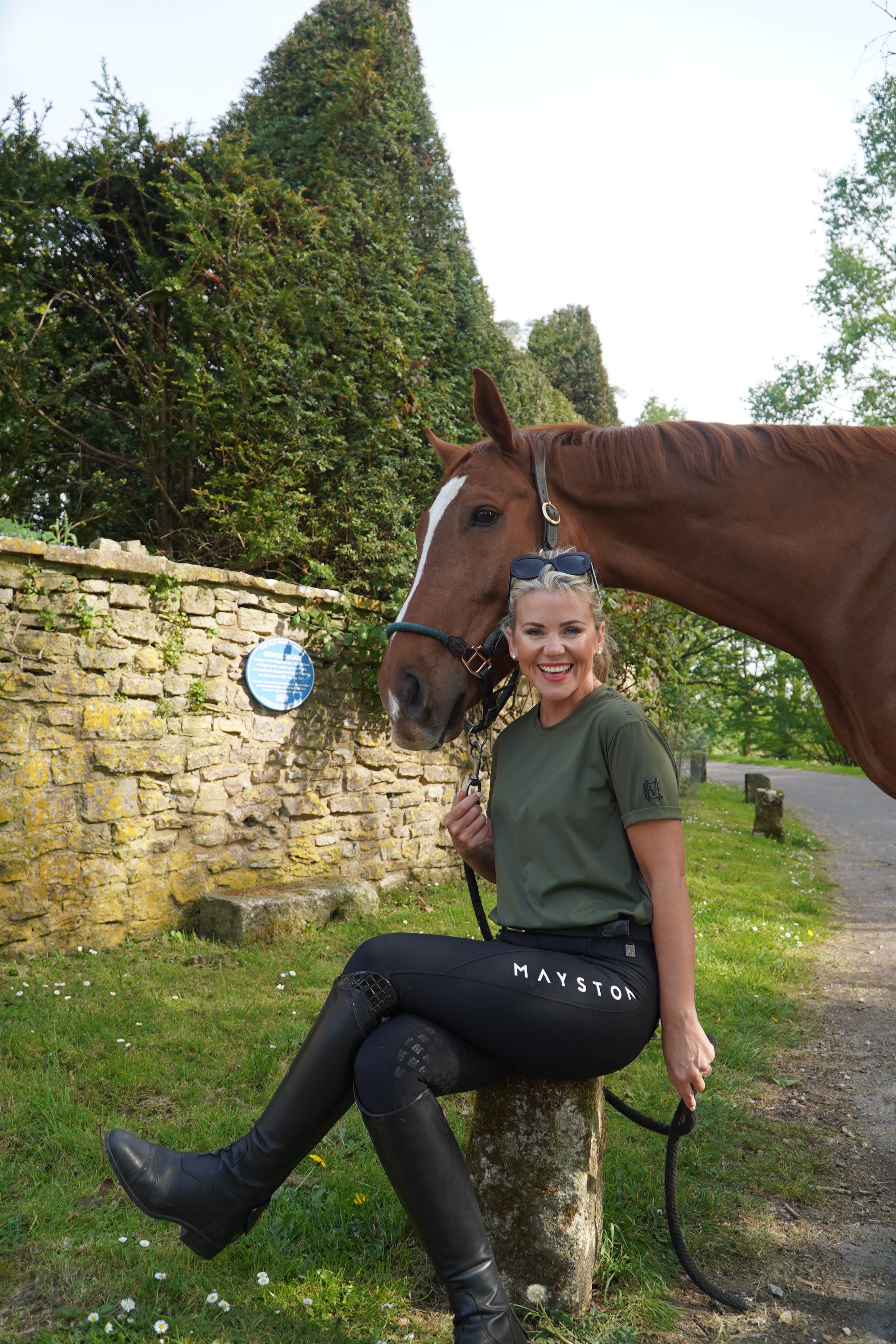 luxury quality t shirt and fabric is specially crafted for active duty, providing flexibility and ease of movement for any busy lifestyle. An ideal choice for a day at the yard, in the saddle, or during your grooming duties, its loose-fitting design guarantees complete freedom. hunter green. woman with horse smiling