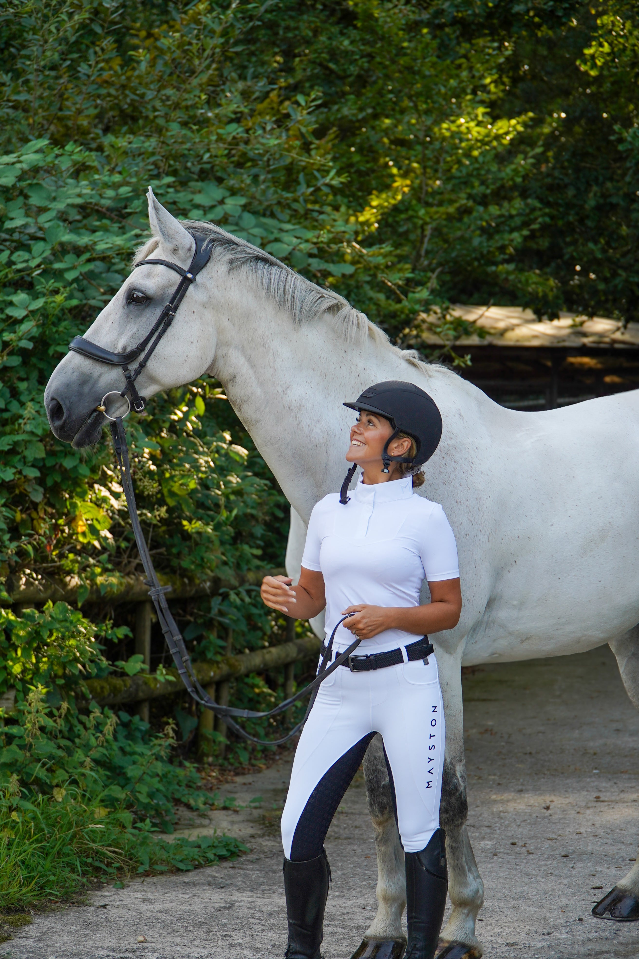 Premium white competition breeches with a black seat. Stretch high waisted Jodhpurs. Deep pockets, supportive, comfortable and compression quality fabric. Elegant detailing with subtle branding.