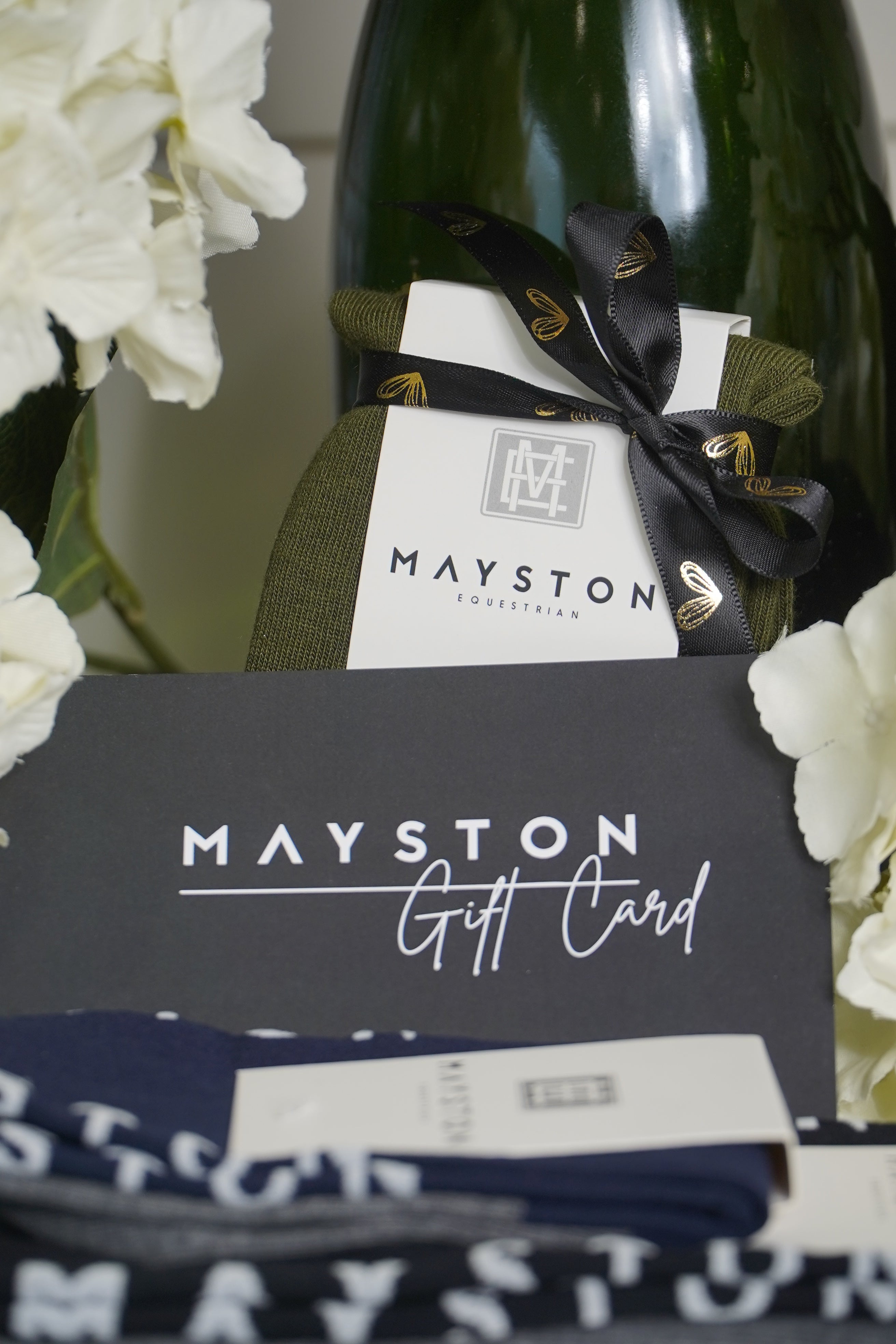 Mayston gift bag with ties and a bottle of wine on a white background